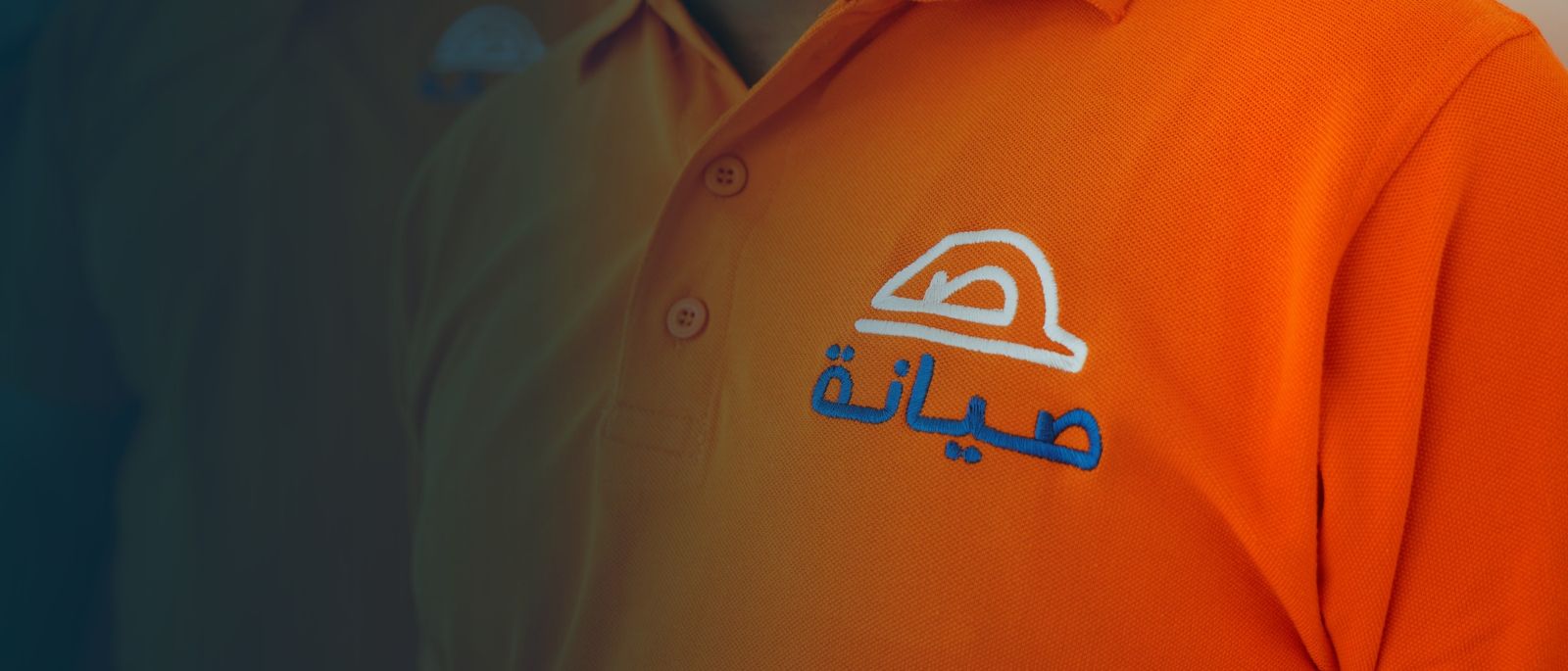 Seyana team members in branded orange uniforms