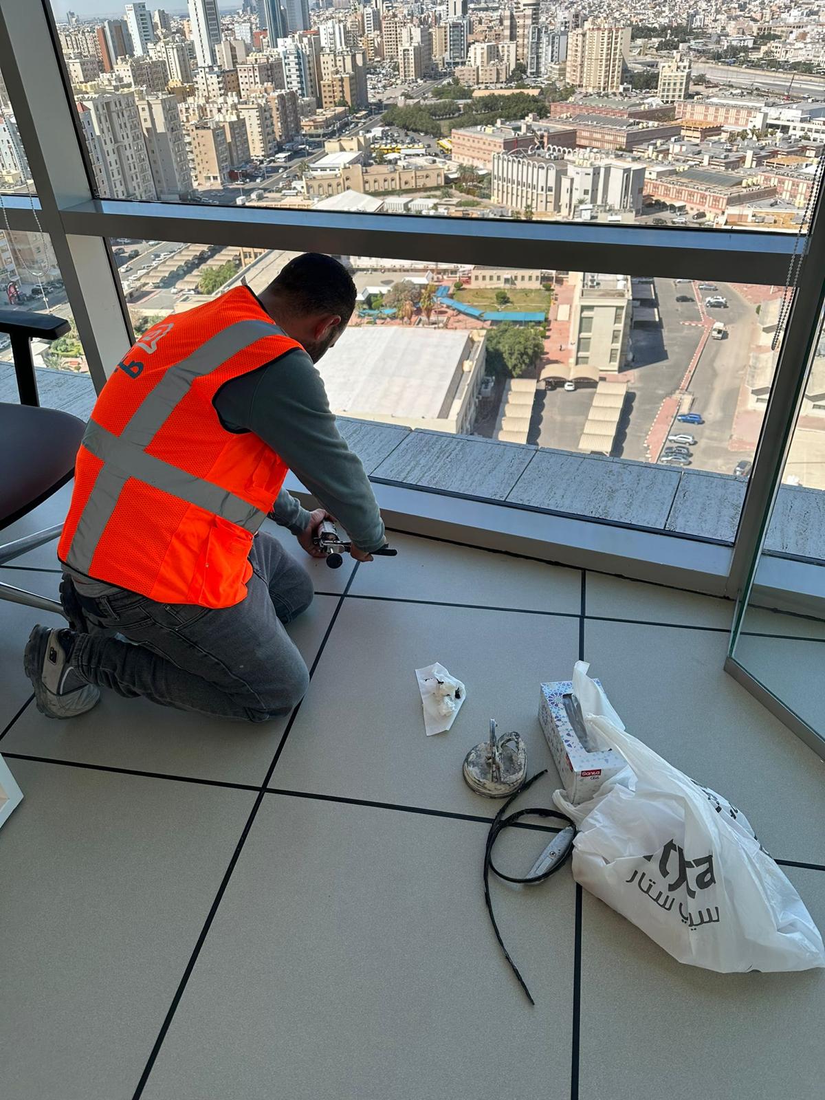 Seyana technician applying silicon sealant at a commercial site
