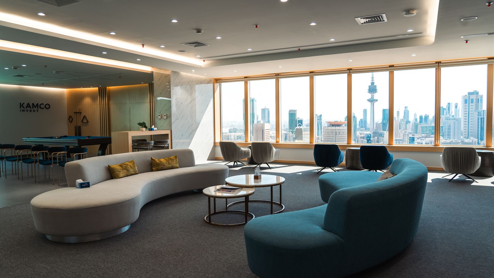 KAMCO Invest executive lounge with signage